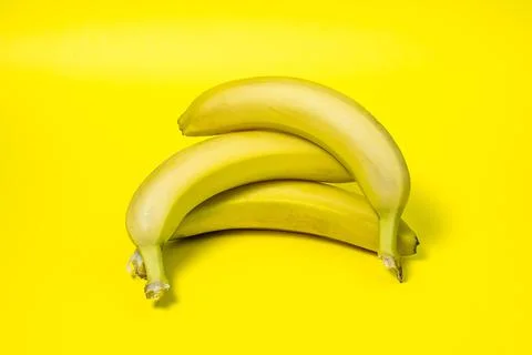 Bananas on a yellow background. Fresh yellow bananas. Stock Photos