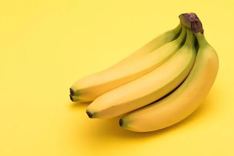 Bananas on yellow background Stock Photos