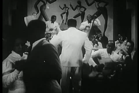 Band leader conducting musicians in1930s nightclub Stock Footage