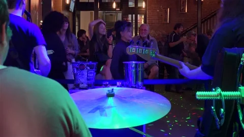 Band live performance and dancing visitors in the 'Drinkery' of Bourbon street. Stock Footage 169794712