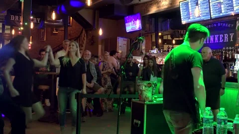 Band live performance and dancing girls in the 'Drinkery' of Bourbon street Stock Footage 195113037