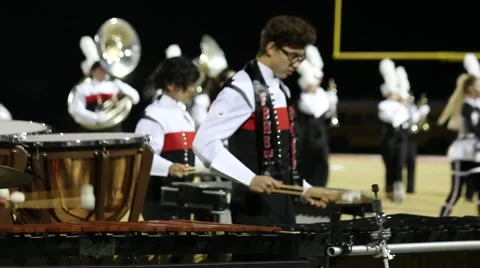 Band Marching in Formation in Background of Members Playing the Marimbas  Stock Footage 43484073