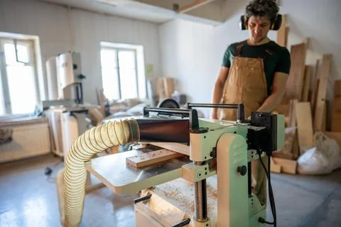 Band saw machine operating. Concentrated craftsman woodworking in studio Stock Photos