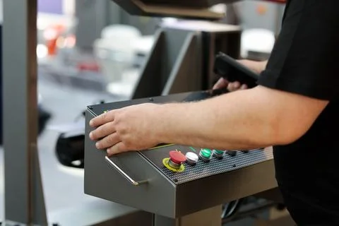 Band saw machine operator at the control console Stock Photos