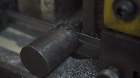 Band saw processing steel rods at a manufacturing plant for precision cutting Stock Footage 294268711