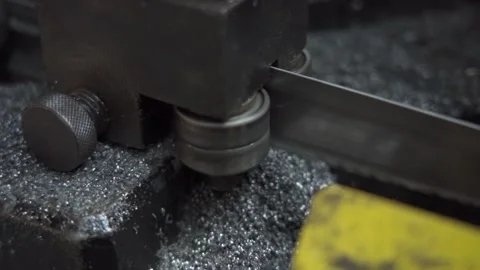 Band saw processing steel rods at a manufacturing plant for precision cutting Stock Footage 294620864