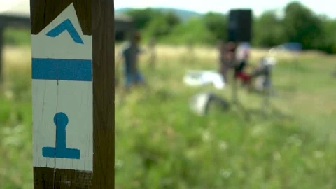 Band setting up behind a blue trail sign Video stock 232757165
