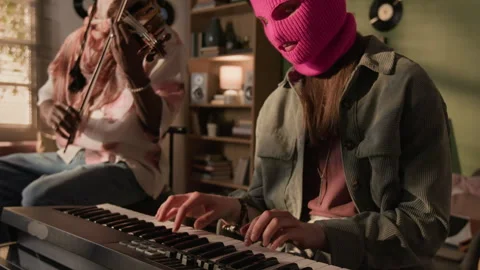 Band of Two Face Covered Performers Playing Violin and Synth at Home Stock Footage 335400687