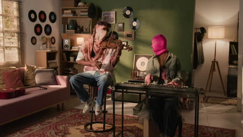 Band of Two Masked Performers Playing Violin and Synth in Living Room Stock Footage 335394750