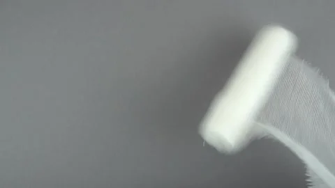 The bandage is unwound on a gray background Stock Footage 150389972