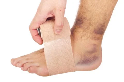 Bandaging a sprained ankle Stock Photos
