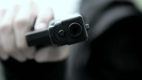 A bandit or robber, a criminal element pointed a gun at someone and demands they Stock Footage 318418078