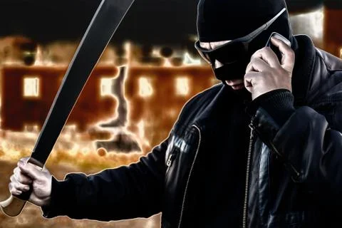 Bandit talking on the phone on the background of burning fire buildings Stock Illustration