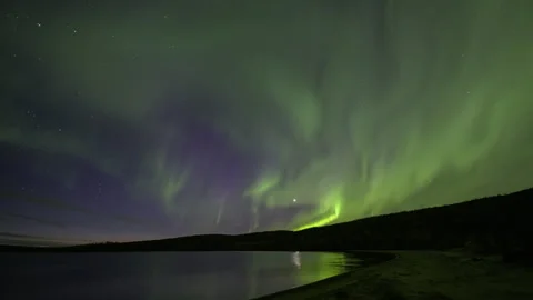 Bands Aurora Borealis over a sandy bay Stock Footage 250295359