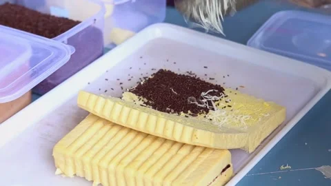 Bandung toast is the process of using additional grated cheese in Bandung toast Stock Footage 265789258