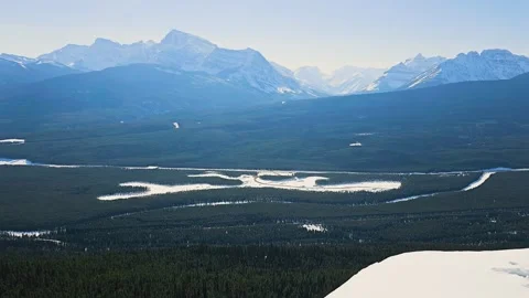 Banff, Canada train moves through a sweeping winter mountain landscape, with 스톡 동영상 334104403