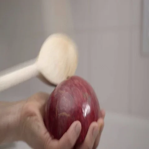 Banging the back of a Pomegranate to release the seeds.  4K UHD. Stock Footage 69701340