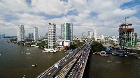 Bangkok and the chao phraya river crossed by modern motorway system in time Stock Footage