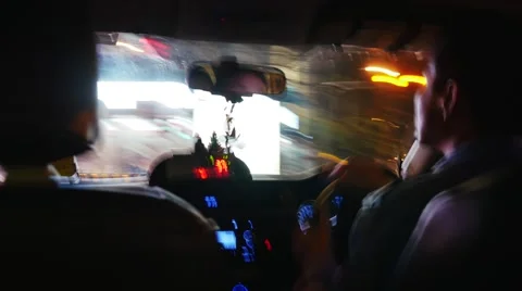 BANGKOK - CIRCA 2015: Driver is driving a taxi in the night city. Motion blur Video stock 48098855