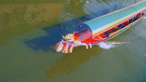 Bangkok -Elevated view of long-tail boat cruising on river. Slow motion. Stock Footage 85478483