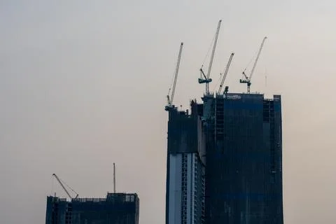 Bangkok High-Rise Development Beneath Multiple Tower Cranes Stock Photos