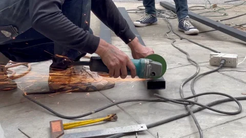 Bangkok. Mechanical engineer using hacksaw to cut metal frame to build the roof Stock Footage 152822012