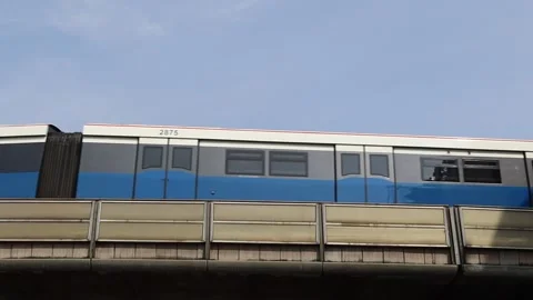BANGKOK, THAILAND - 04/27/2021: Sky train BTS running to stop at the station Stock Footage