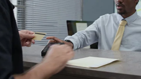 Bank Manager Giving Wireless Terminal to Client Using Credit Card in Office Stock Footage 314173883