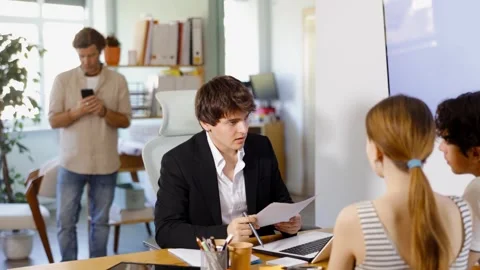 Bank manager talks with young in office Video stock 342126234