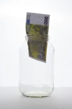 Bank note in jar on white background Stock Photos