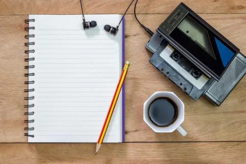 Bank notebook with pencil laying on the brown table. Stock Photos