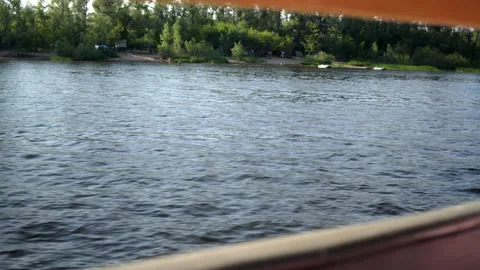 Bank of the river from behind the side of the ship. Walk across the river 4k Stock Footage 157073016
