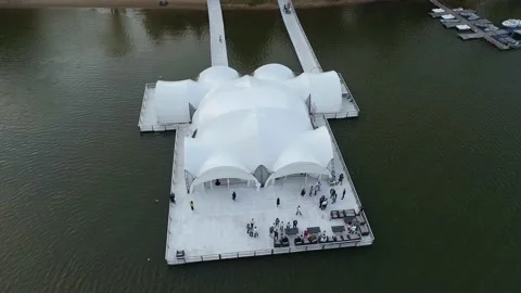 On the bank of the river with a high forest. The drone hovered over the pier on Stock Footage 169583887