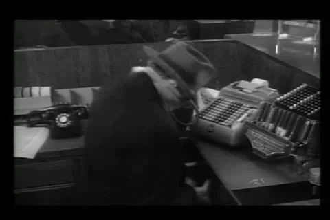 Bank robber trying to open stuck drawer Stock Footage 11349558
