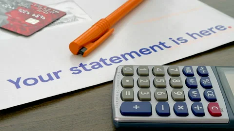 Bank statement letter to be checked with plastic card, pen and calculator. Stock-Footage 154738953