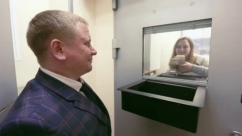 The Bank teller sends the money to the customer. Stock Footage 80356076
