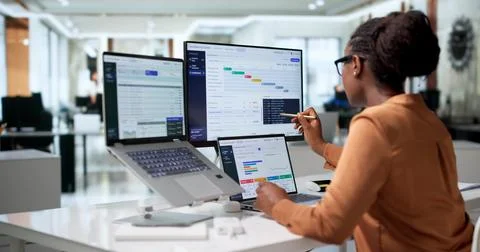 Banking Manager Carefully Analyzes Digital Financial Transactions Using Lapto Stock Photos