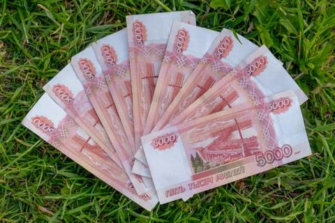 Banknotes 5,000 Russian rubles on grass green background. Russian rubles. Mon Stock Photos