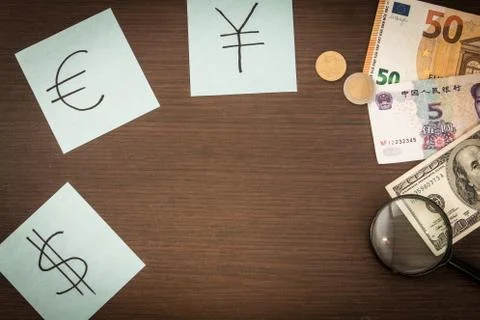 Banknotes and coins lying on notepad, stickers with currency signs and Magnif Stock Photos