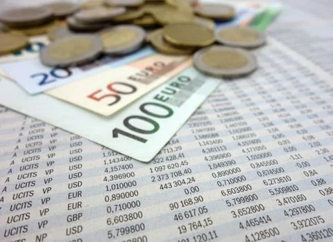 Banknotes and coins on the stock numbers Stock Photos