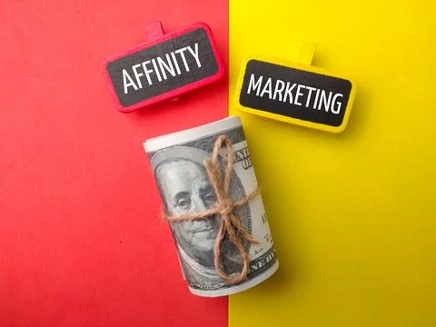 Banknotes and colored board with text AFFINITY MARKERTING Stock Photos