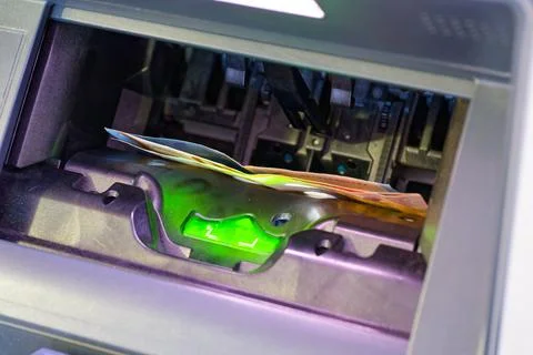 Banknotes being counted inside an automatic currency counting machine Stock Photos