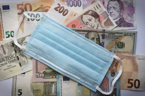 Banknotes of different countries background, top view and medical face mask Stock Photos