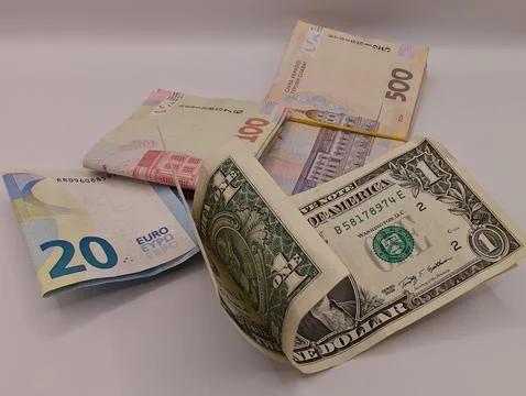 Banknotes of different countries on a light table macro photography Foto stock