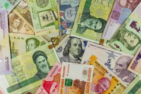 Banknotes of different countries spread around the banknote 100 US dollars. C 스톡 사진