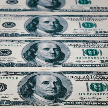 Banknotes of dollars are stacked in a row. Stock Photos