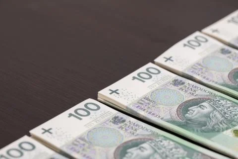 Banknotes evenly distributed on a dark brown desk ready for use. 写真素材