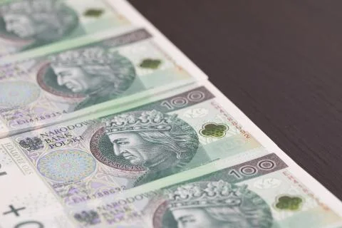 Banknotes evenly distributed on a dark brown desk ready for use. Fotos Stock
