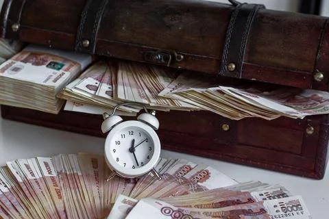 Banknotes with five thousand rubles lie in a wooden chest, of Russian rubles. Stock Photos