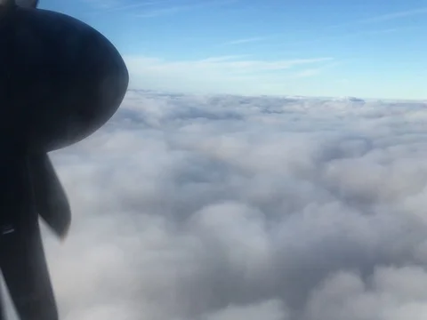 Banks of Clouds float by, viewed from the window of a commercial airline (4K) Stock-Footage 79796314